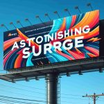 High-definition image of the billboard advertisement for an energy company named 'Astonishing Surge'. The ad features bold typography and dynamic, abstract shapes to depict the concept of defying industry trends. It includes a vibrant color scheme that stands out against a clear blue sky, effectively communicating the innovative spirit of the company.